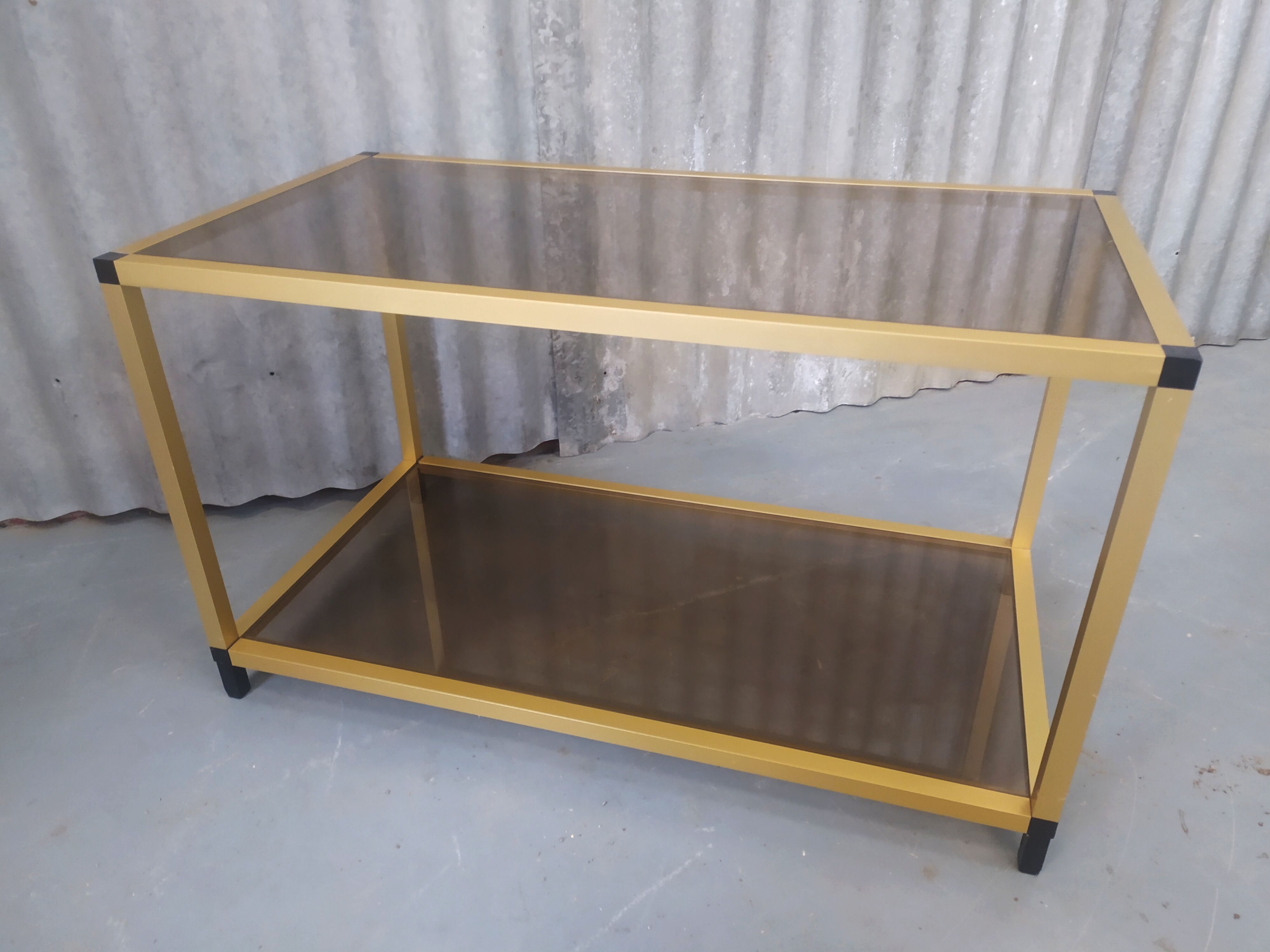 Gold metal coffee table and smoked glass