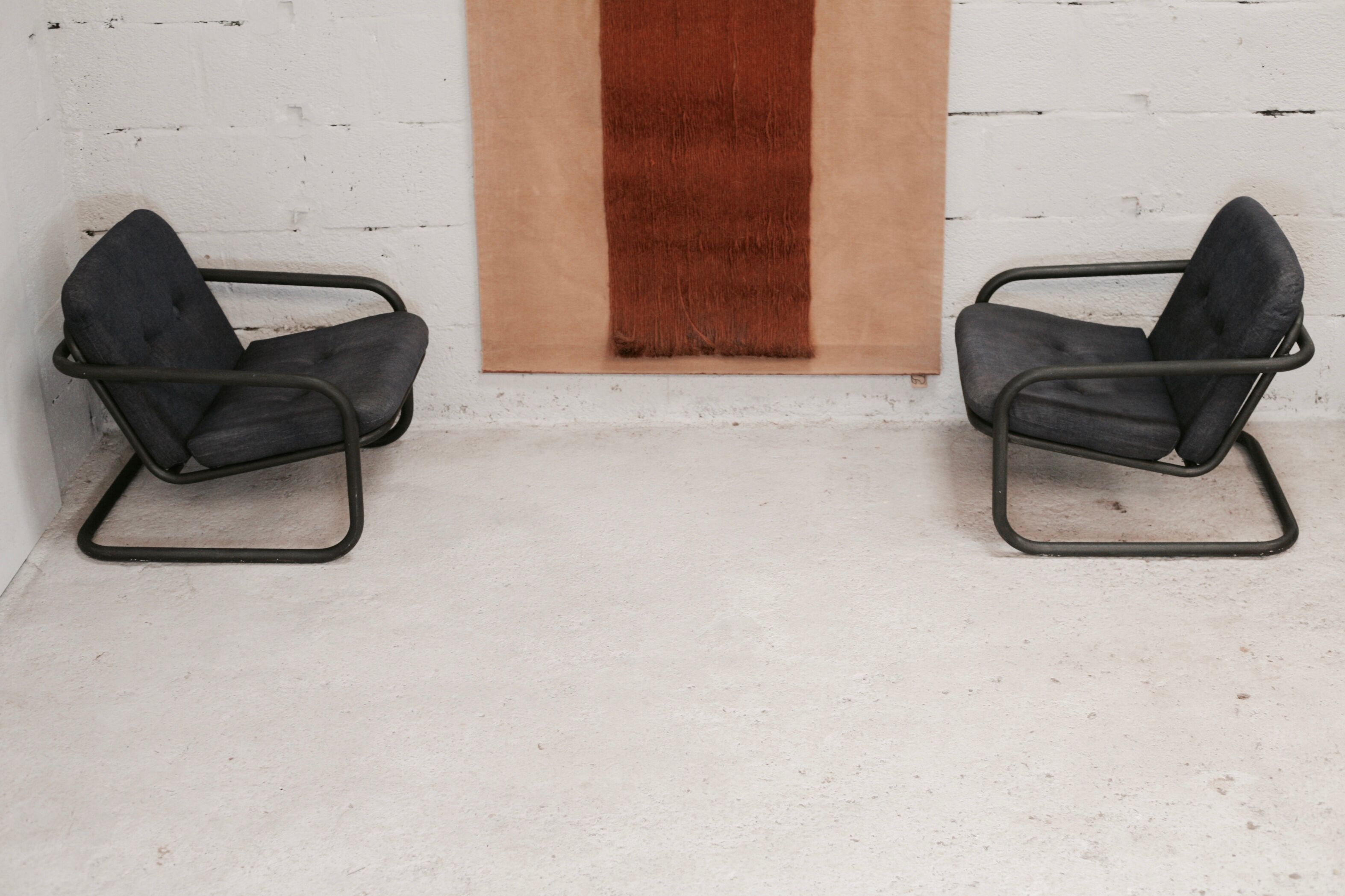 Pair of Prisunic edition armchairs, tubular steel and foam cushions, France, 1973