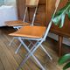 4 folding Sintesi chairs for DWR Lina in metal and vintage camel leather.