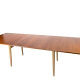 Dining table in teak and oak with extensions designed by Hans J. Wegner