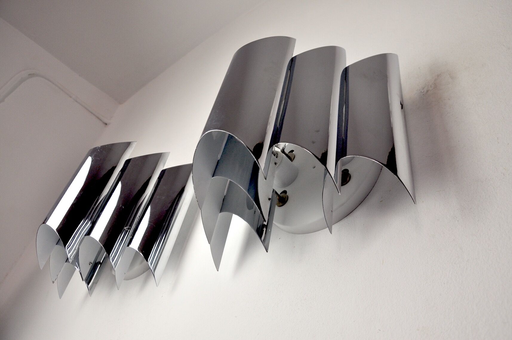 Pair of Raak wall lamps, space-age chrome design, Germany, 1970