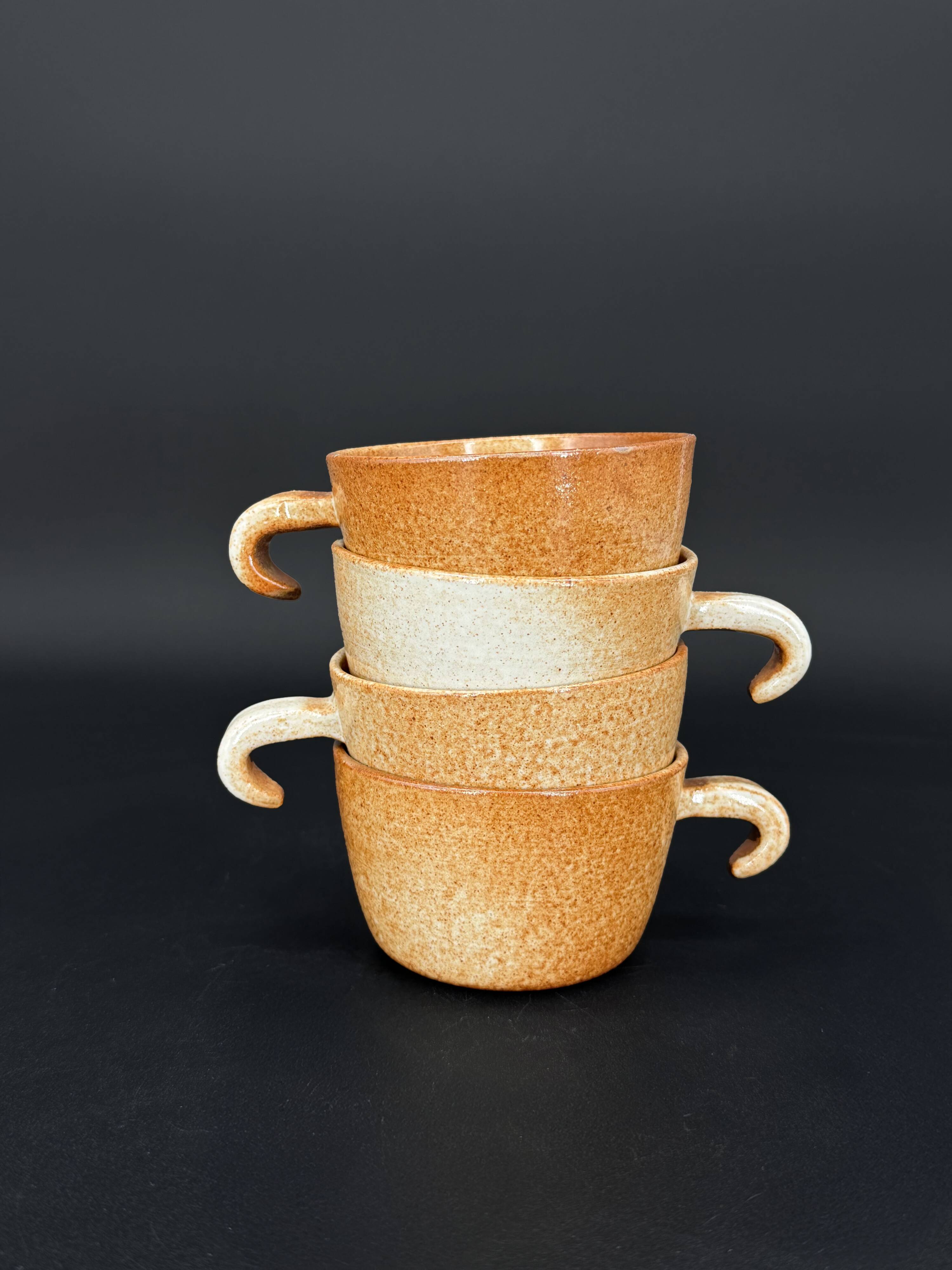 4 cups in glazed stoneware with graphic handles