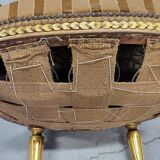 A pair of gilded wooden armchairs in the Louis XVI style.