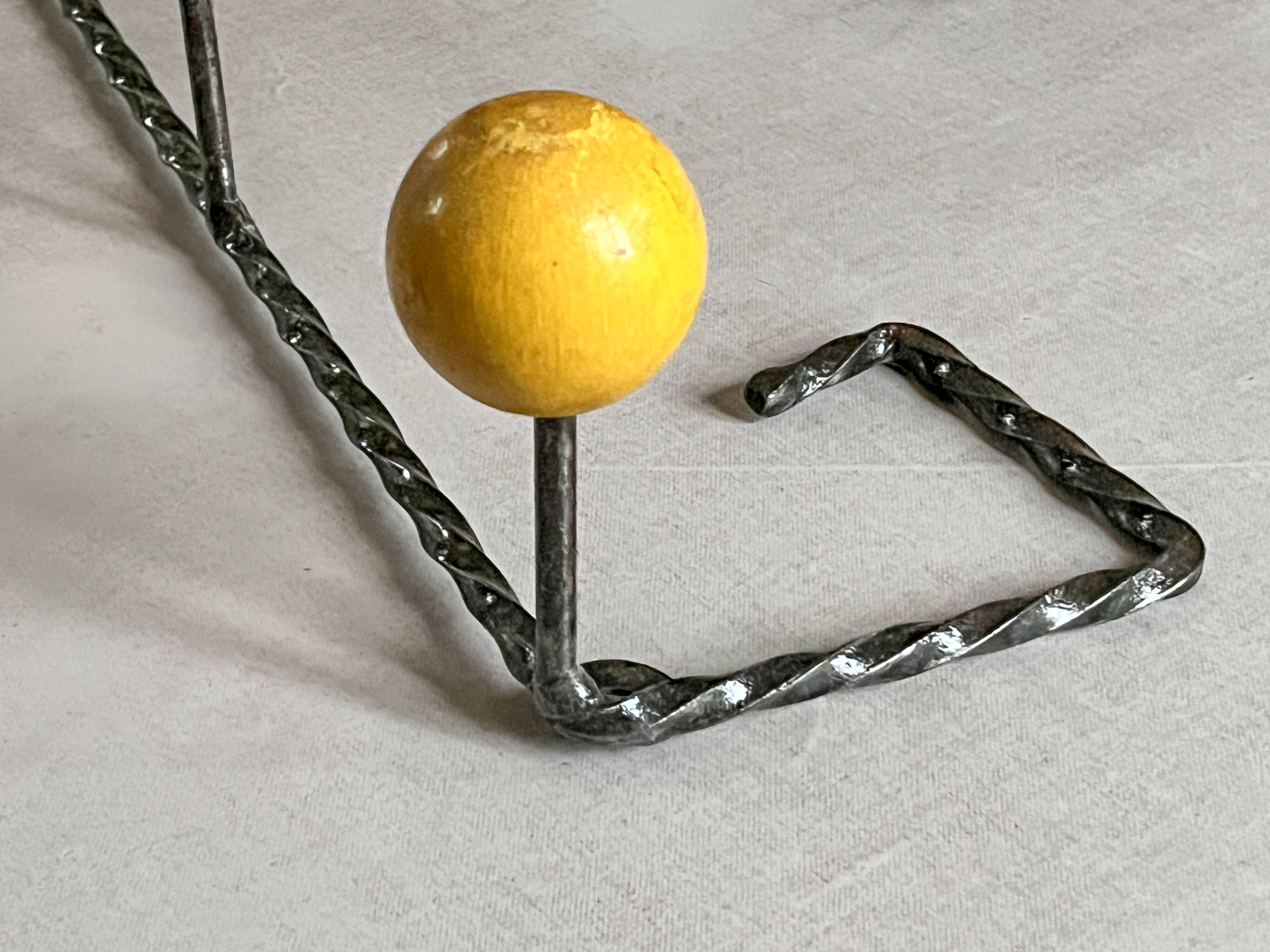 Wall-mounted coat rack in metal and wood with 3 hooks, antique item.