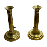 Duo of brass push candle holders