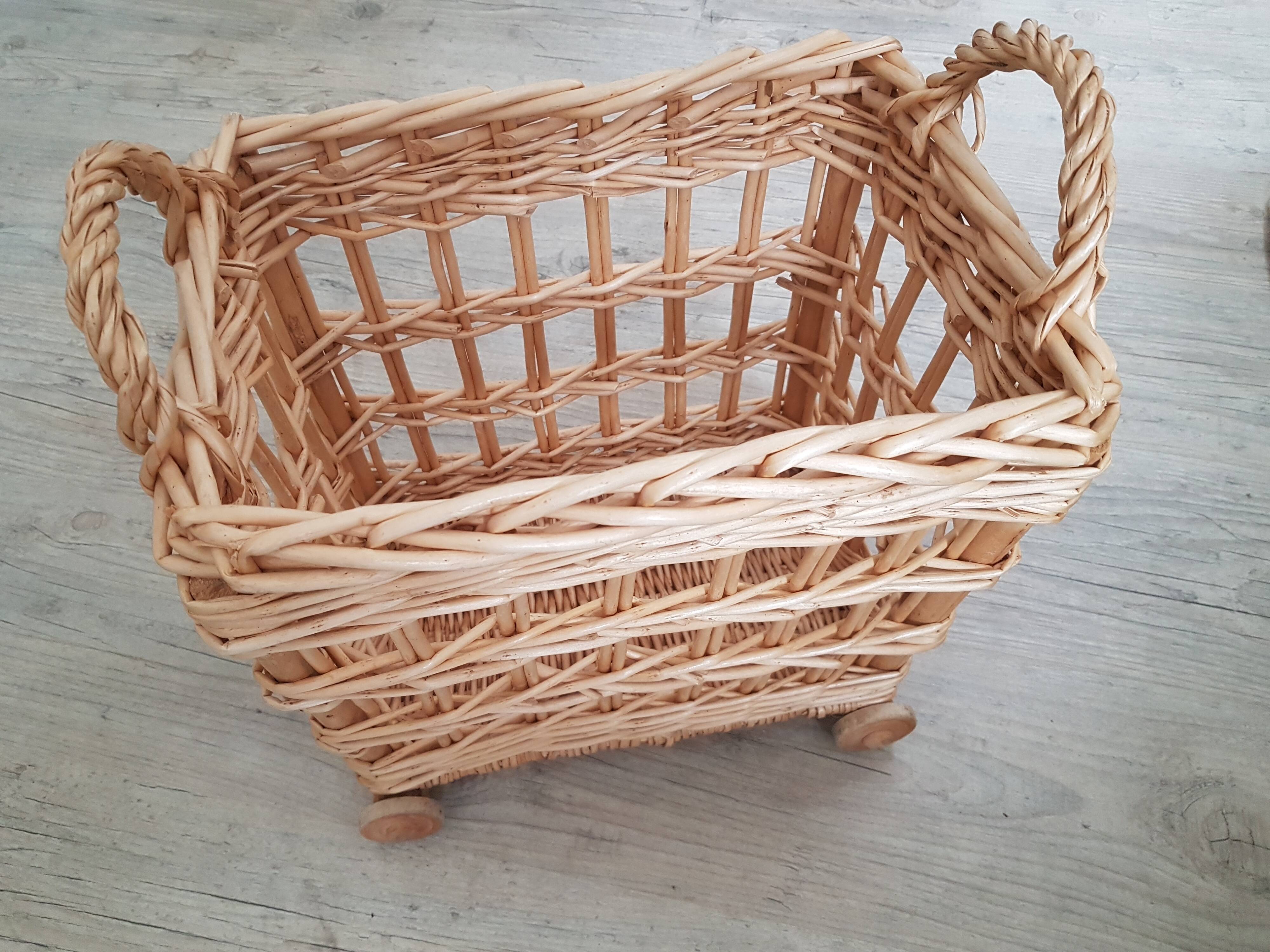 Vintage wicker basket on wheels - children's toy trolley