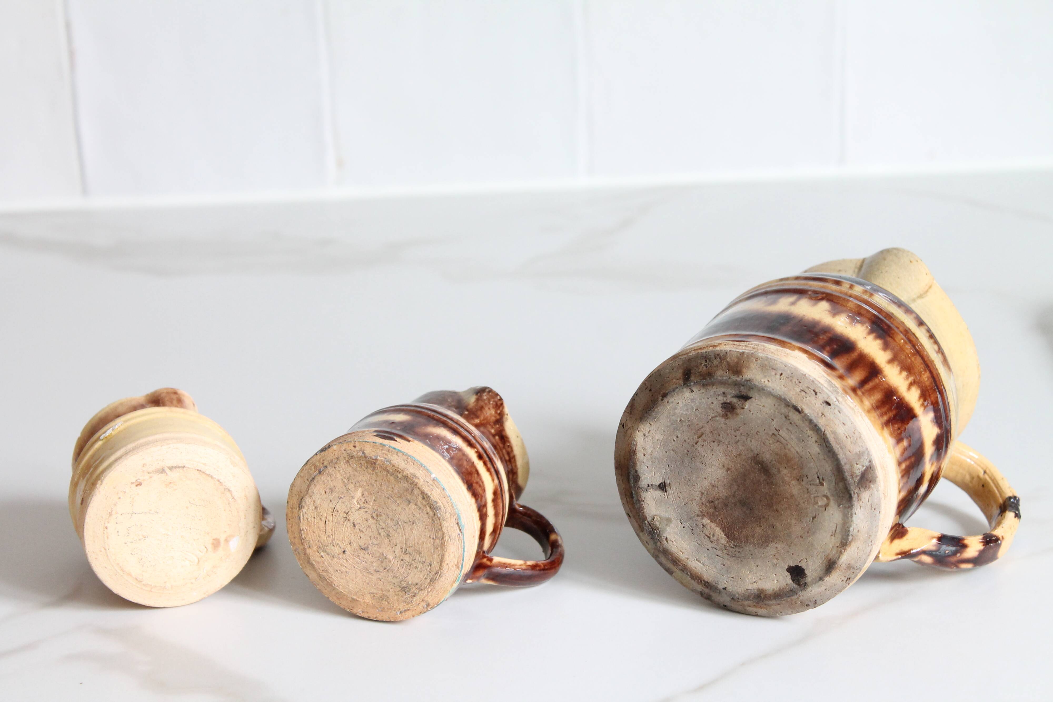 3 old bicoloured enamelled stoneware jugs