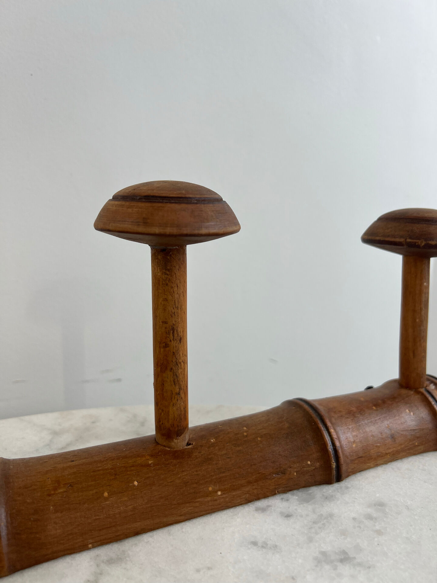 Wooden coat rack with three ball hooks.