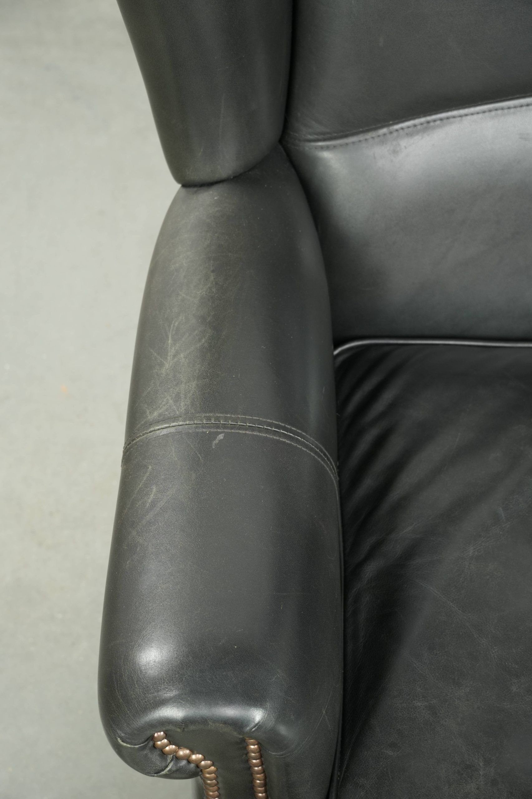 Black cowhide wingback armchair in classic English style