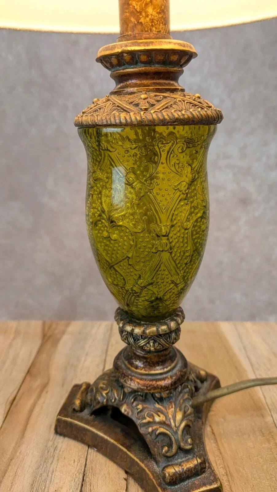 Vintage lamp with bronze imitation base & green relief glass in an antique style.