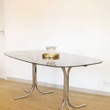 Dining table with smoked glass top and chrome base.