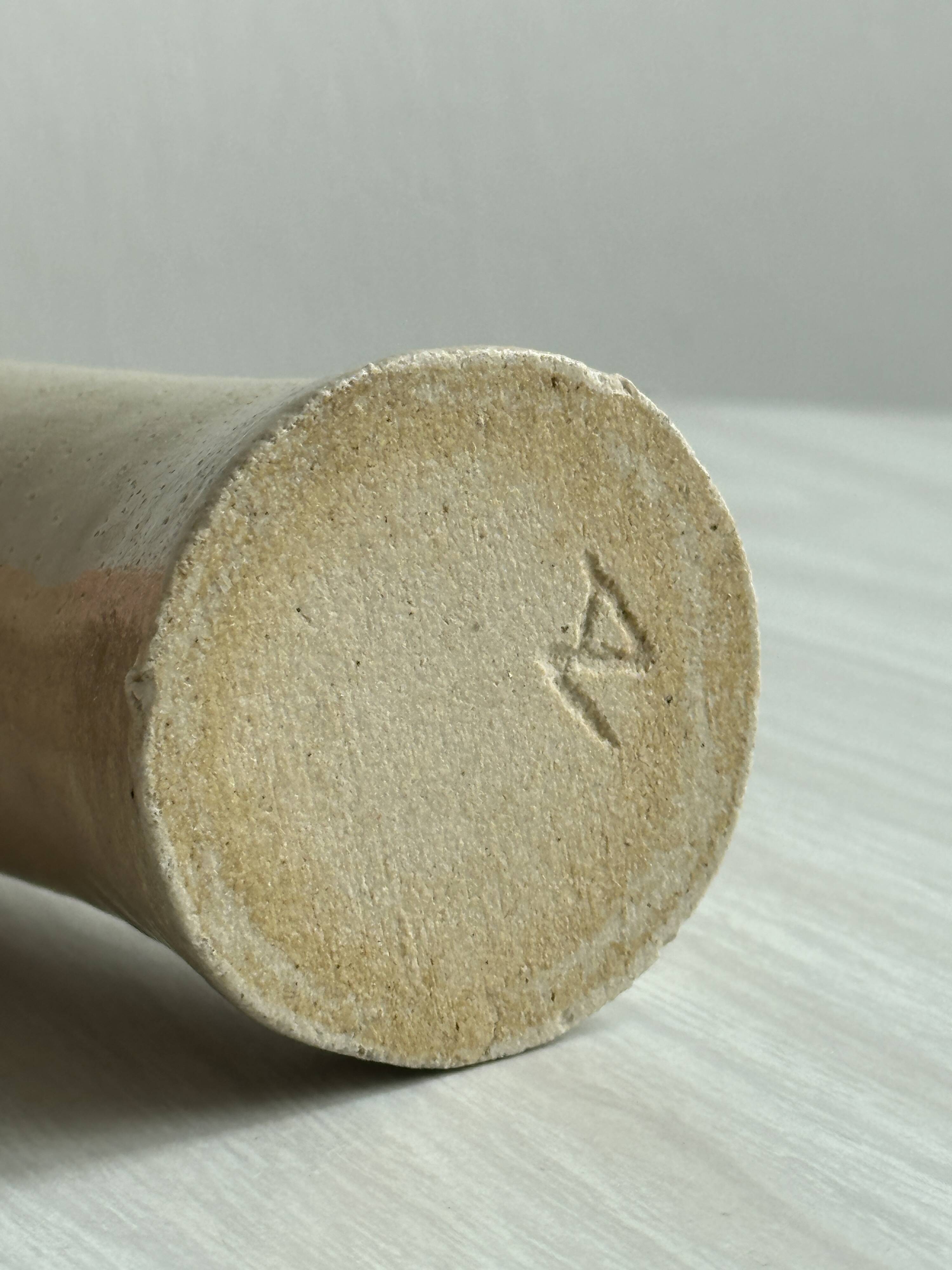 Minimalist beige ceramic vase.