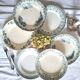 Mismatched antique flat plates made of ironstone pottery.