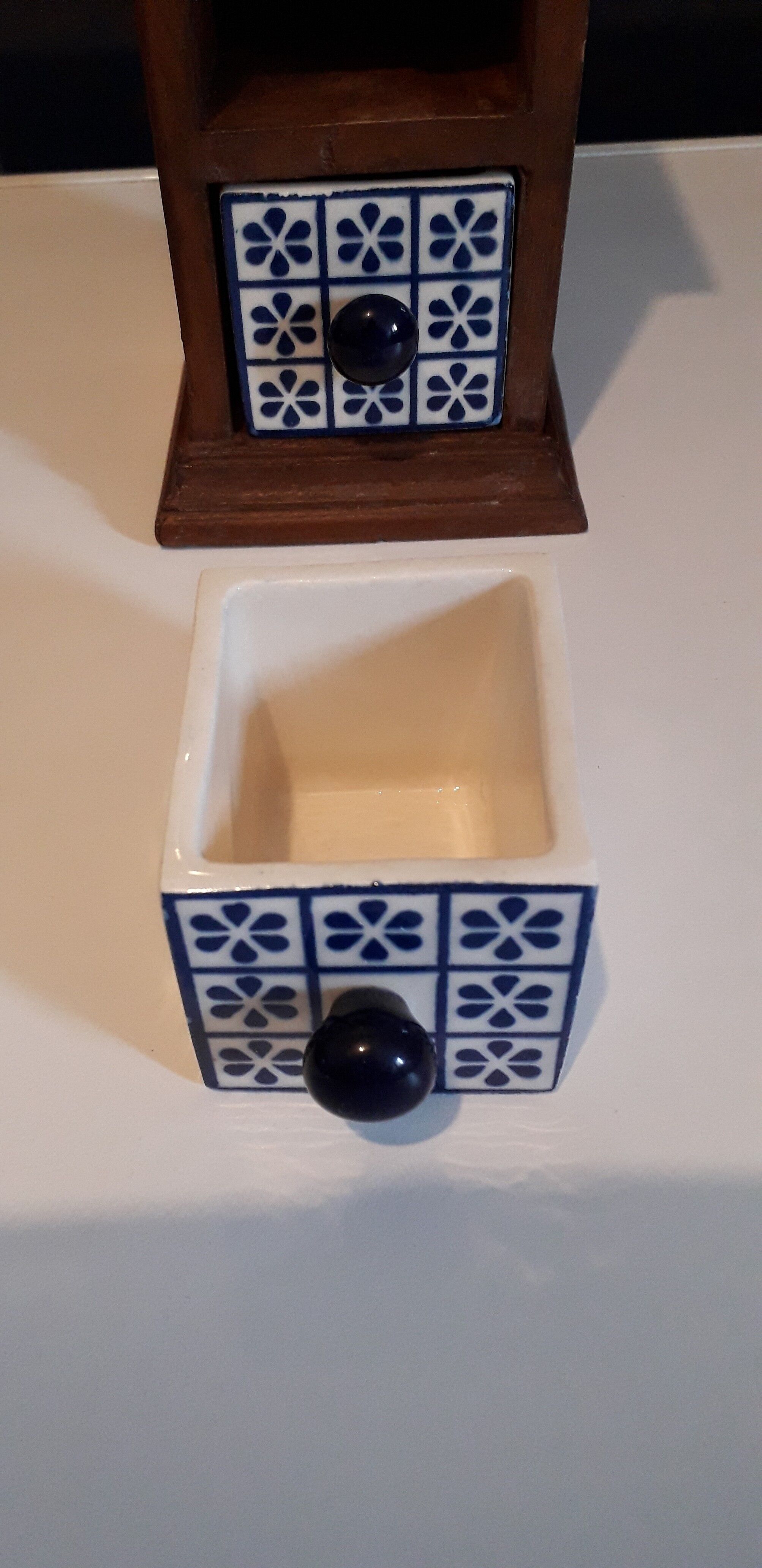 Storage in the form of a small wooden cabinet, with 3 ceramic drawers.