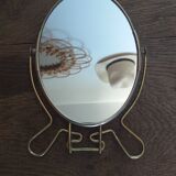 Vintage oval mirror on suspended stand