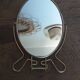 Vintage oval mirror on suspended stand
