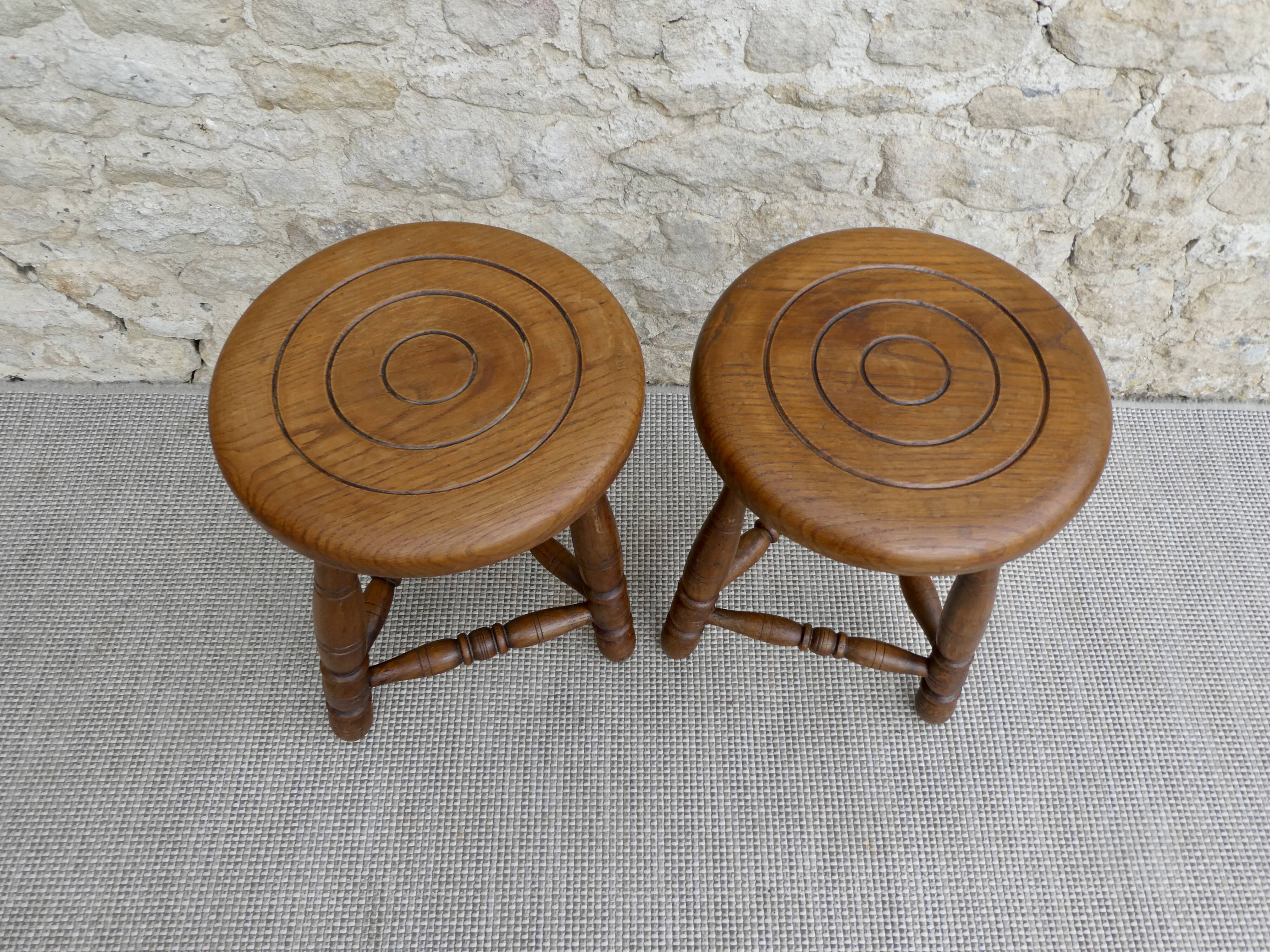 Pair of solid wood tripod stools, carved.