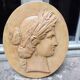 Plaster medallion, high relief, yellow ochre patina, representing the Roman divinity Ceres