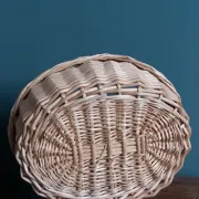Handcrafted wicker basket with a handle.