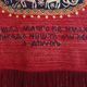 Vintage handwoven tapestry with a folk scene and archaic Slavic writing.