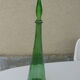 Vintage green faceted glass bottle with its cap 1970