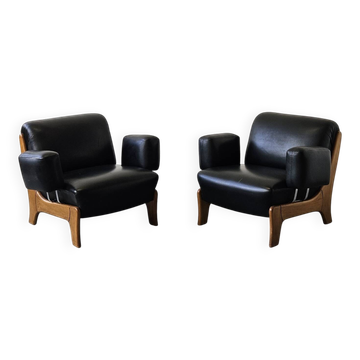 Pair of vintage brutalist armchairs, leather and wood, 1970s.