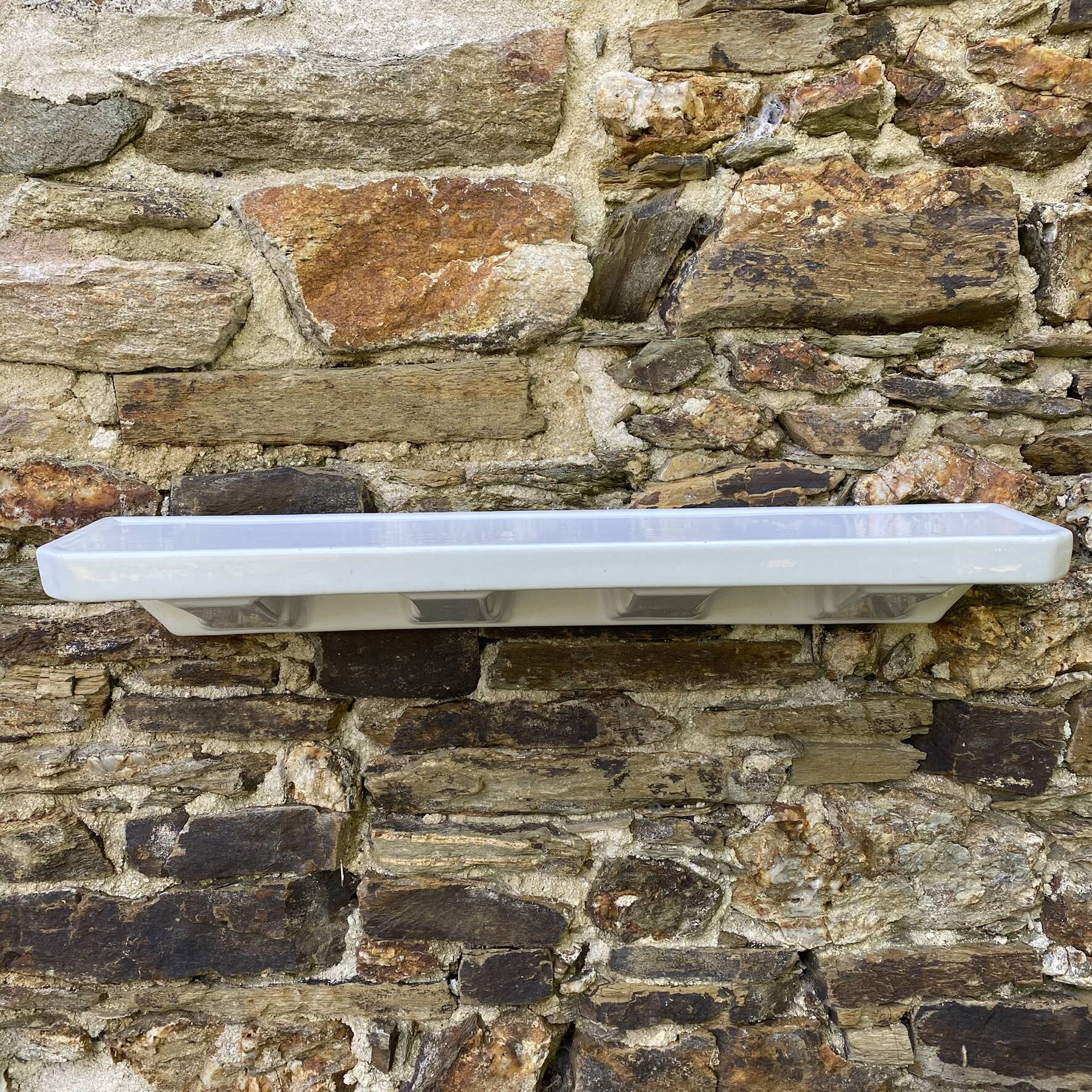 Antique wall shelf for bathroom in white porcelain.