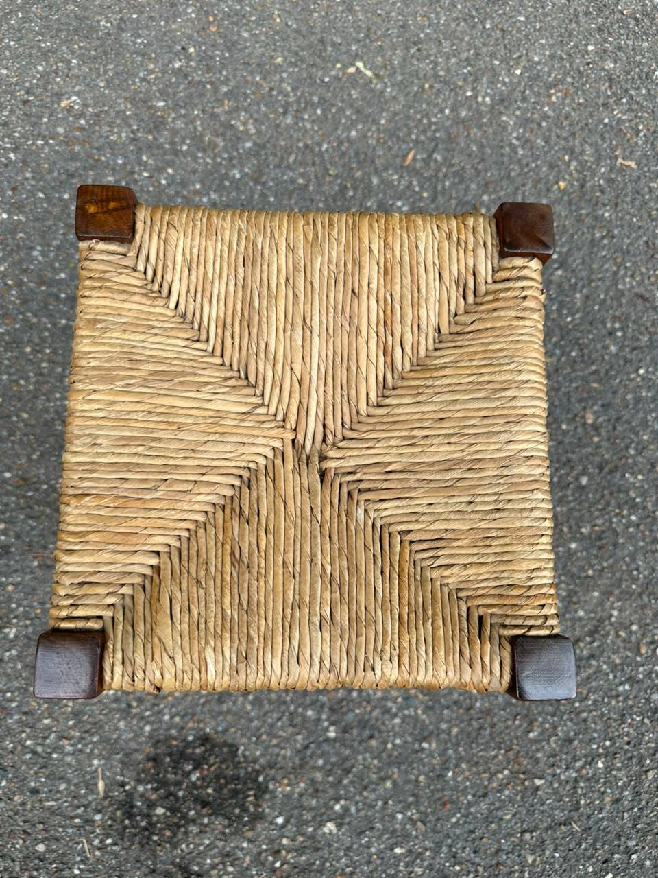 Low stool in brutalist style made of solid wood with straw, 1980.