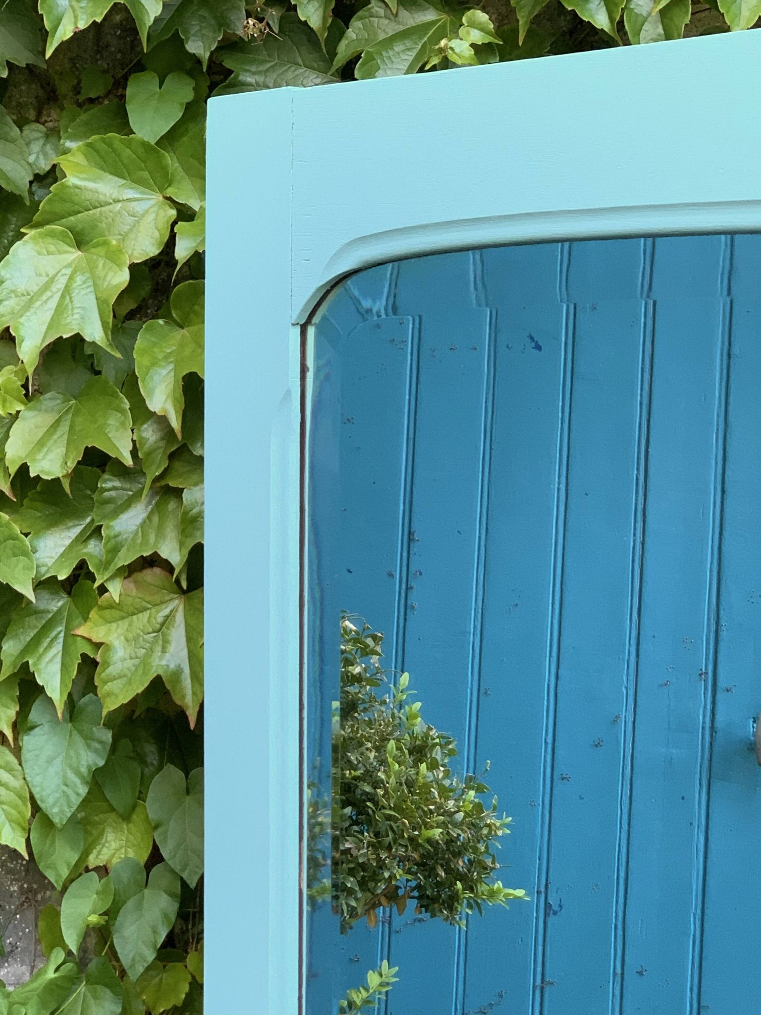Beveled mirror on turquoise Parisian door