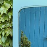 Beveled mirror on turquoise Parisian door
