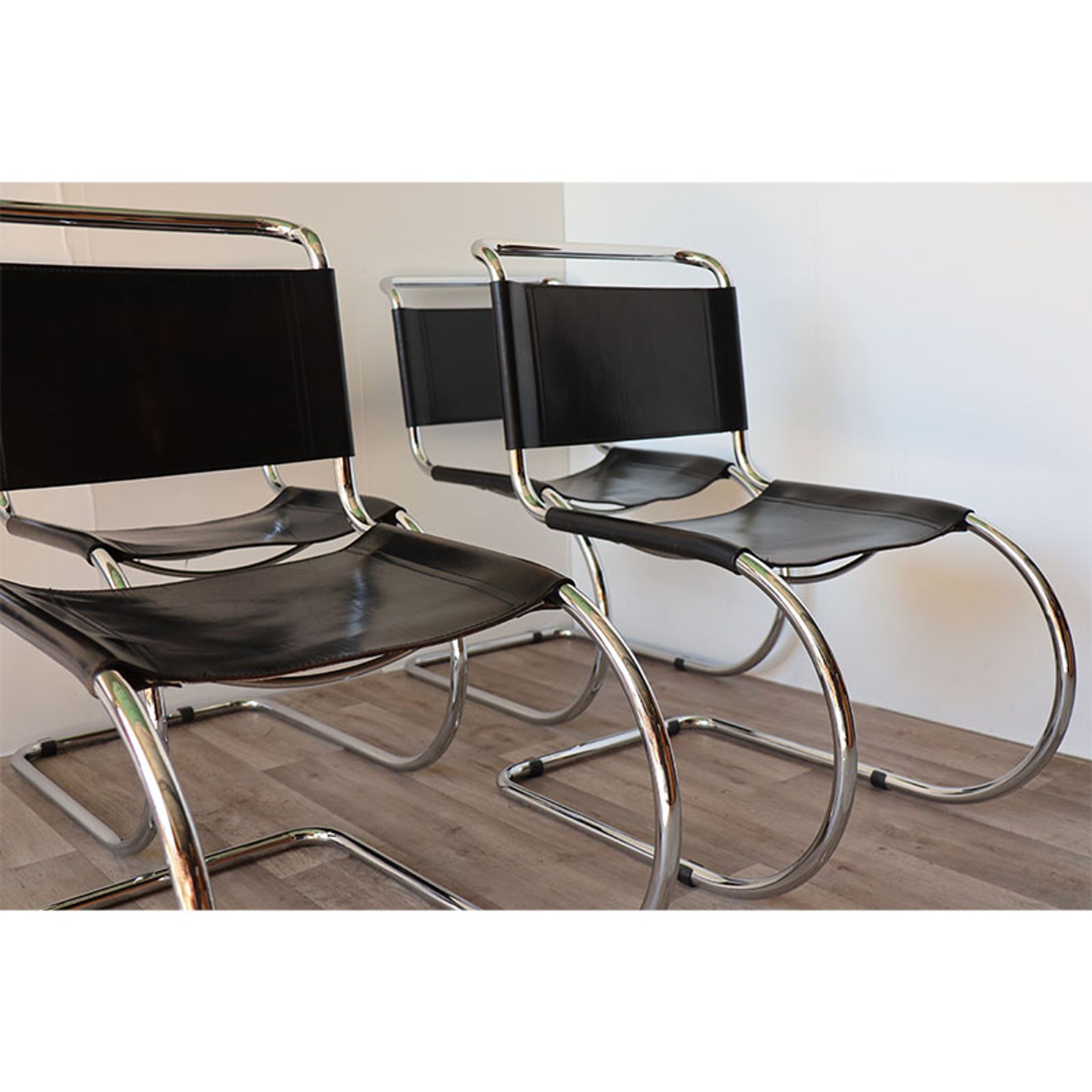 Series of 6 minimalist chairs in chrome metal and black leather around 1970