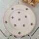 7 mismatched antique dessert plates accompanied by a pie dish