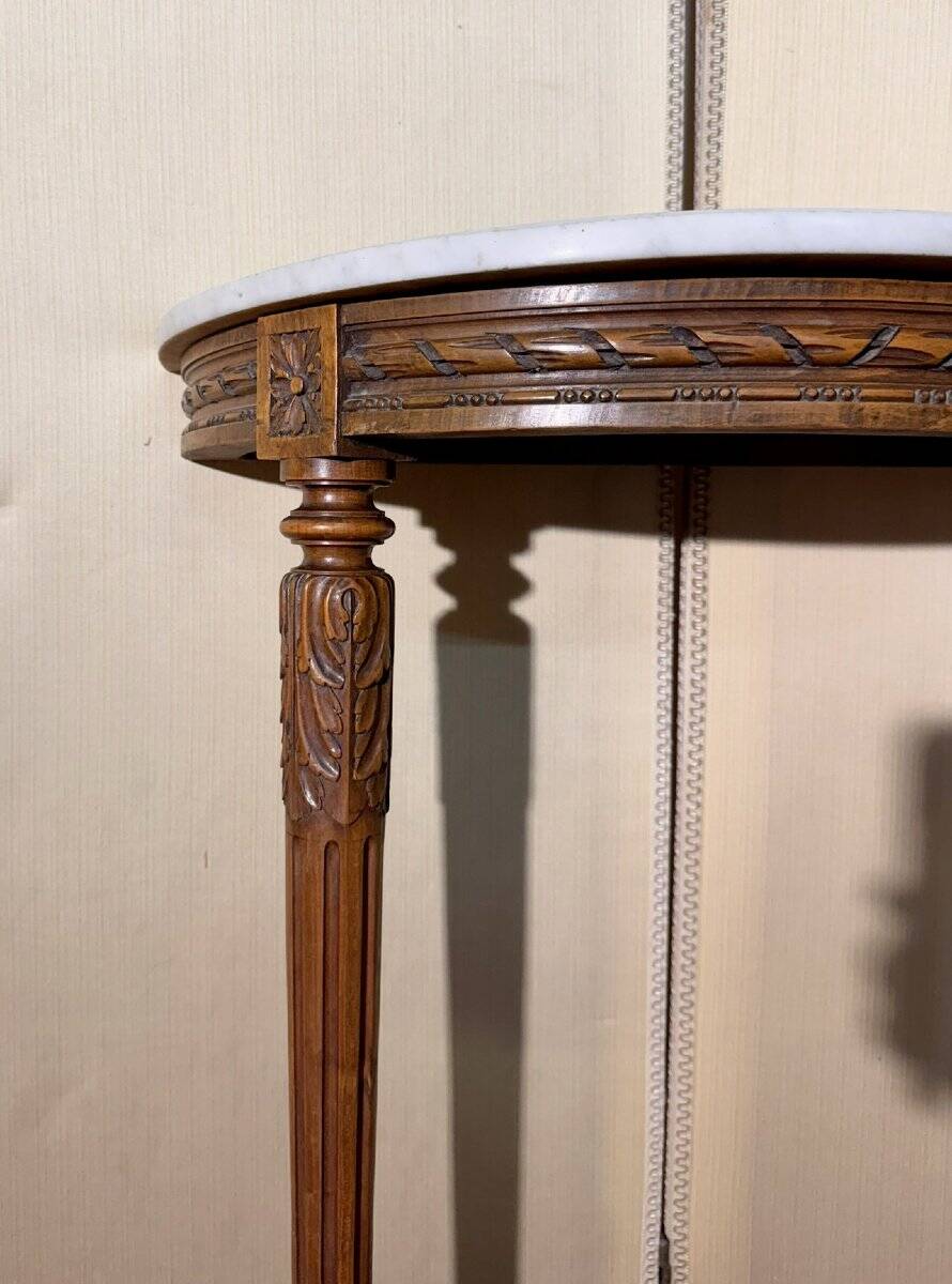 Half-moon console in Louis XVI style made of carved wood.
