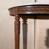 Half-moon console in Louis XVI style made of carved wood.