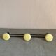 2 black and yellow metal wall coat racks