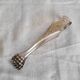 Antique silver-plated sugar tongs with lion's paws.