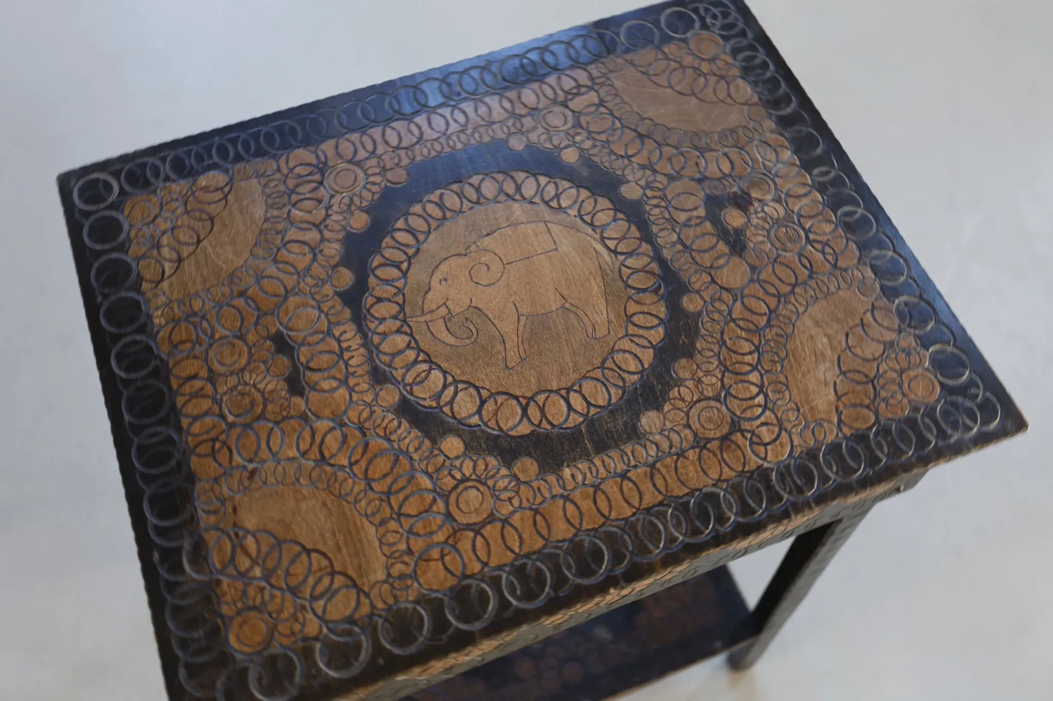 Decorated antique side table with elephant