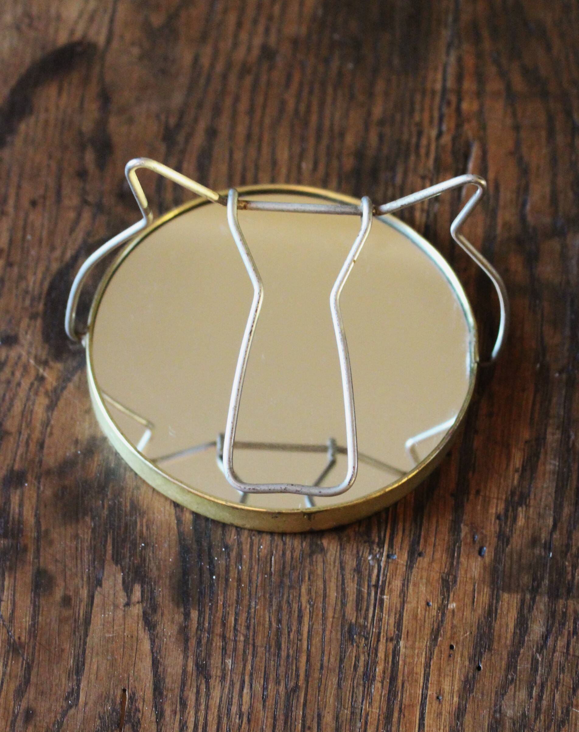 Antique round barber mirror in gilded metal