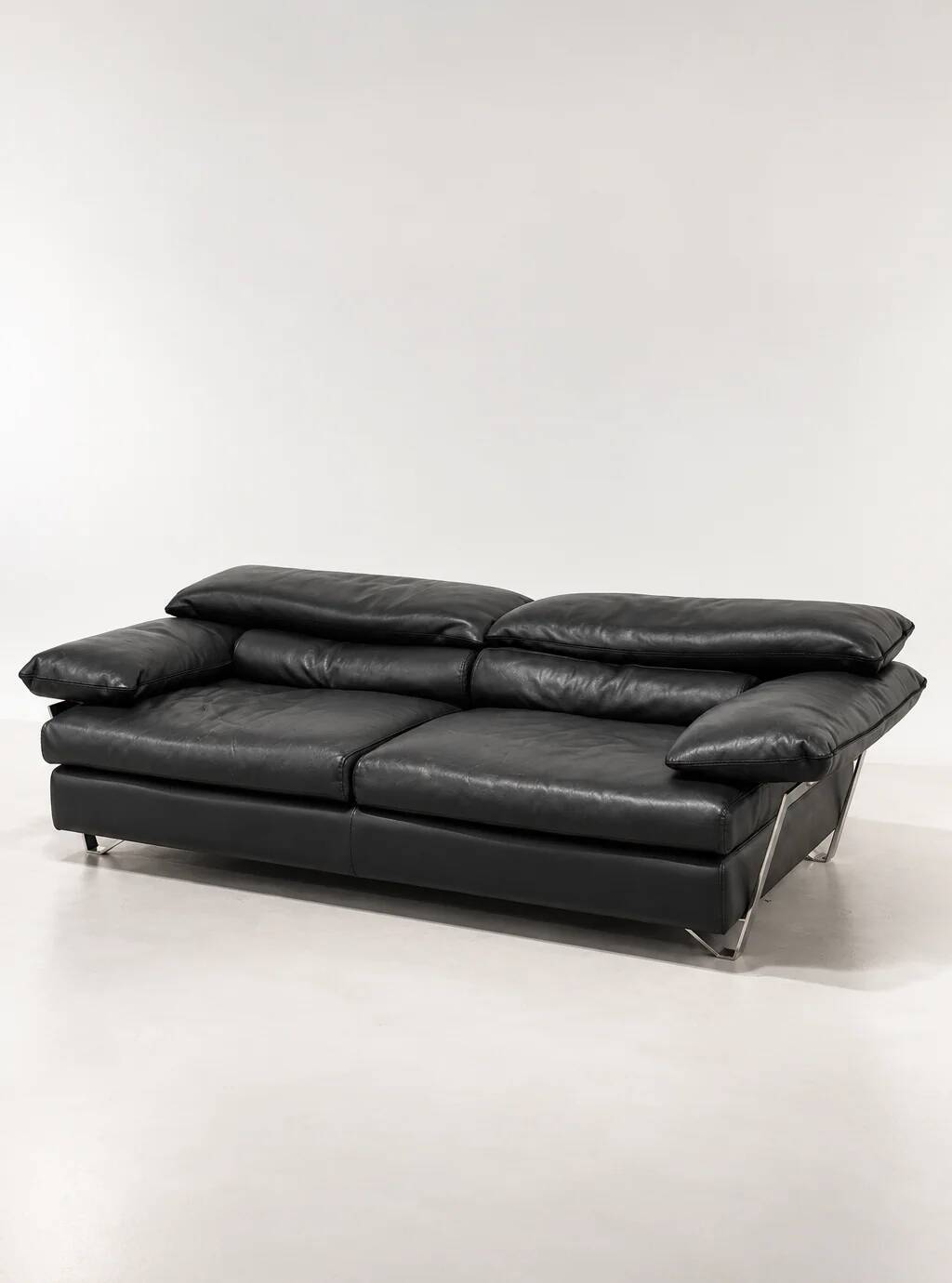 Two-seater black leather sofa from Roche Bobois with a chrome frame.