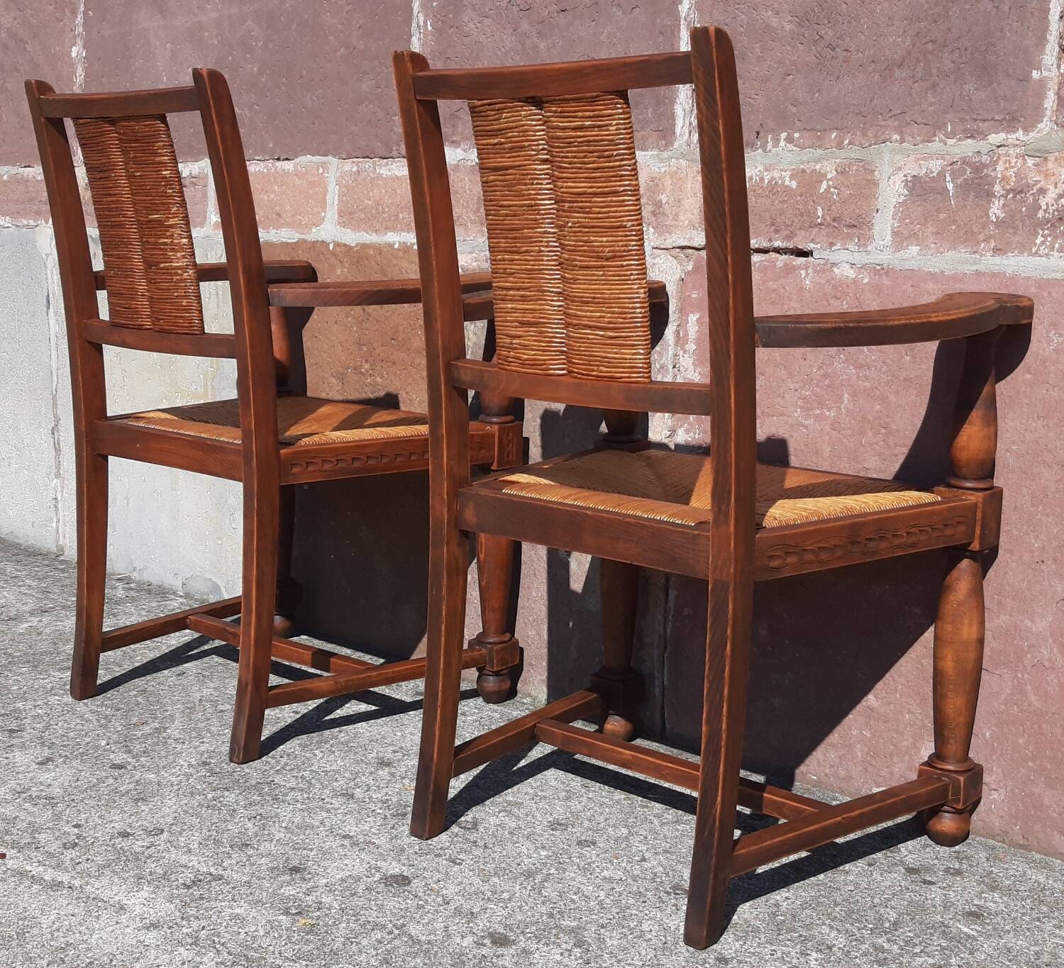 Pair of oak armchairs with straw seats and backs.