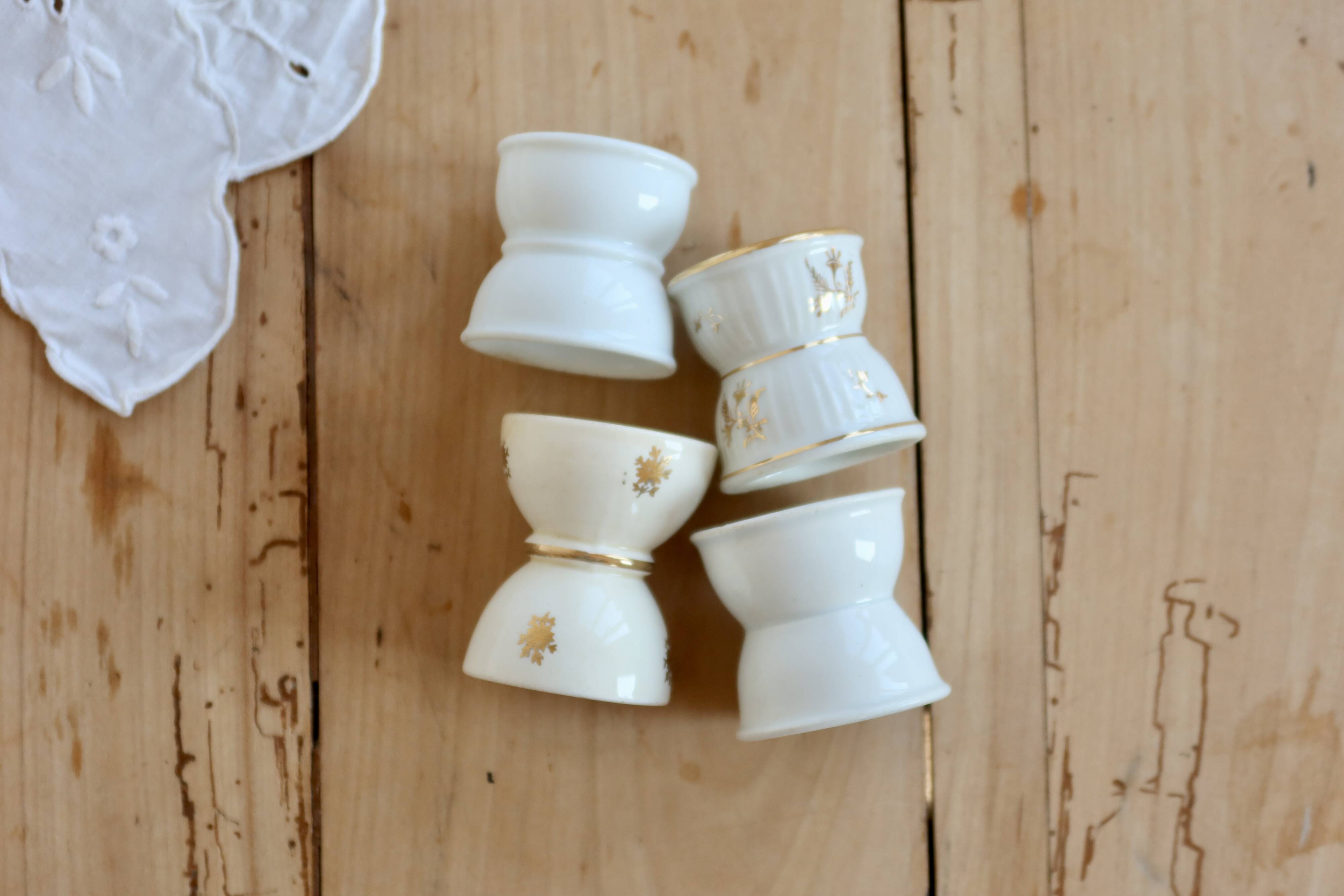 4 mismatched vintage diabolo egg cups in earthenware