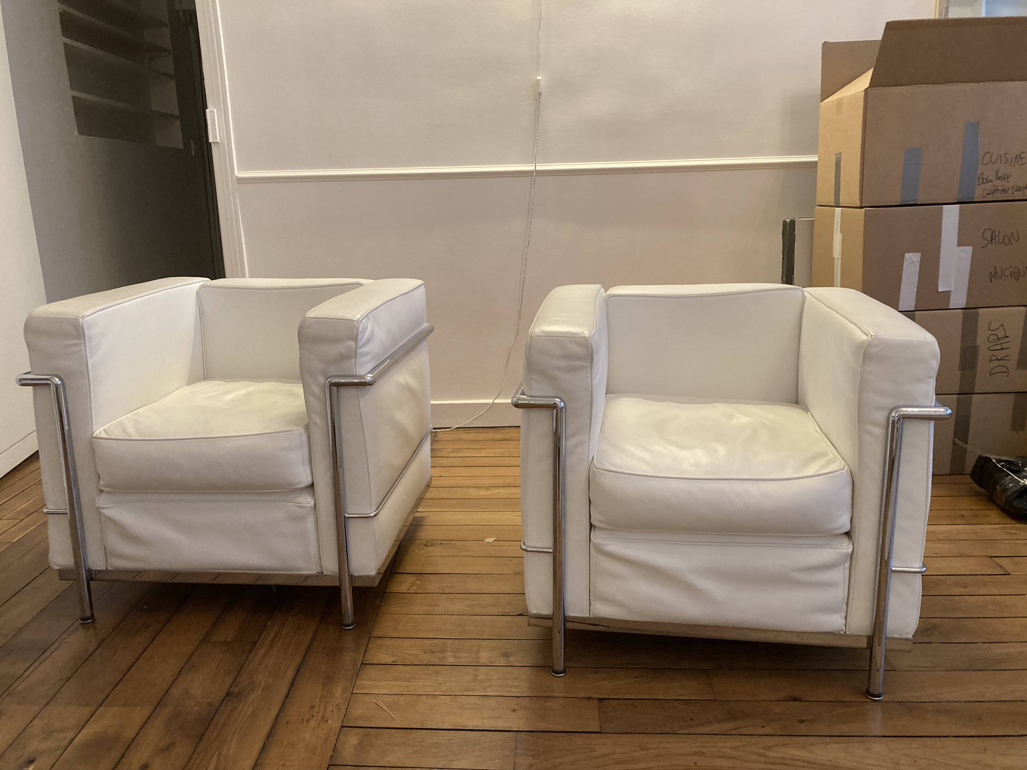 Pair of white leather and chrome armchairs