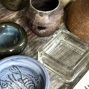 Glazed blue ceramic bowl with stylised fish decoration.