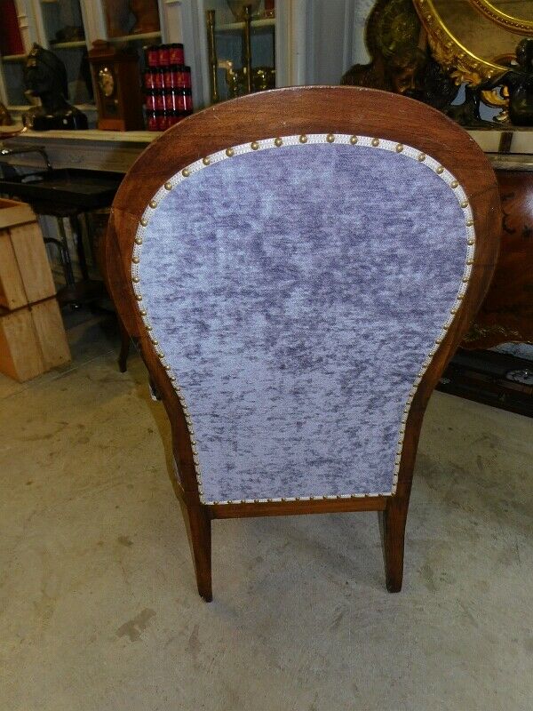 Relaxed Voltaire armchair with walnut racks