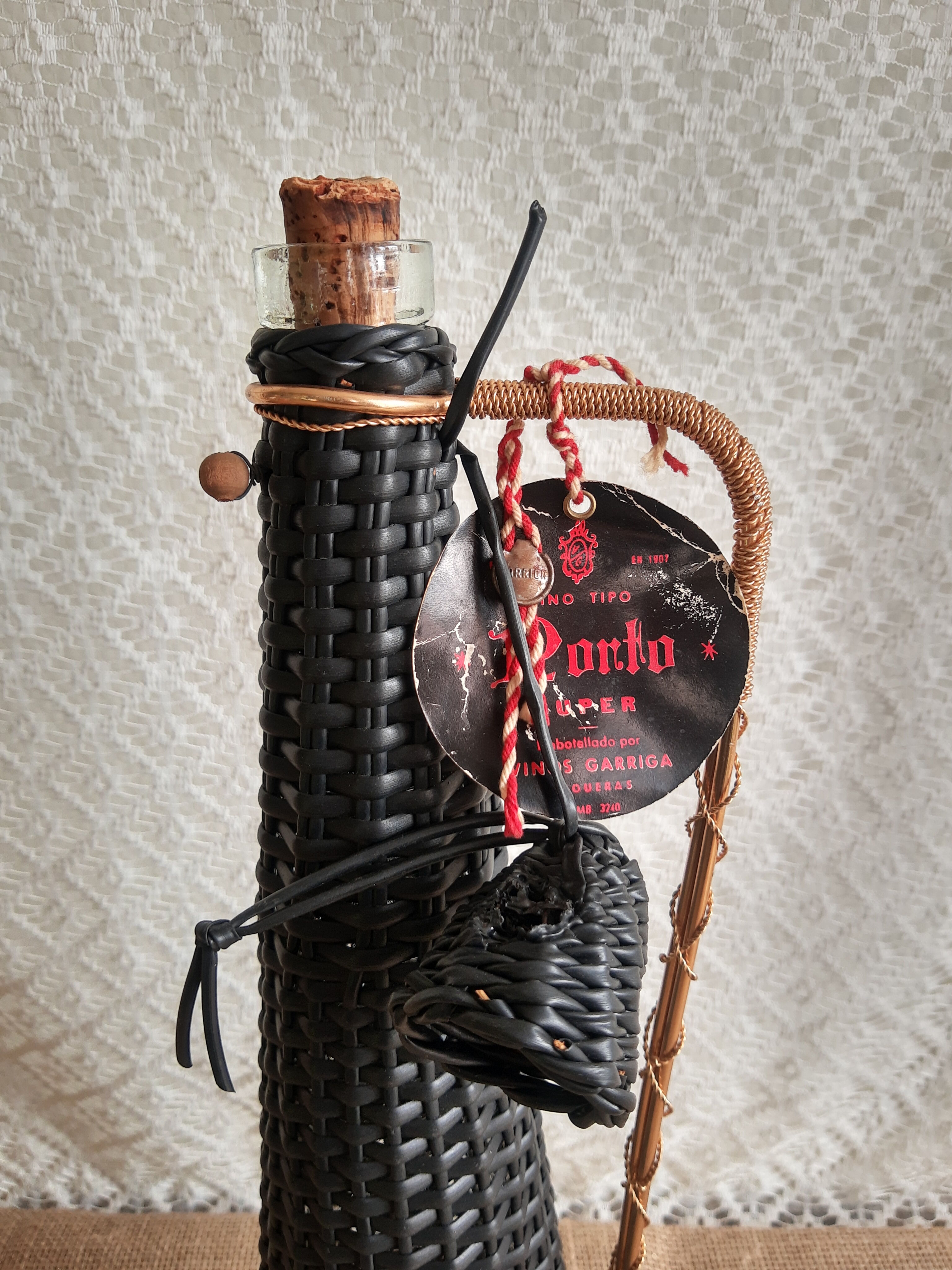 Glass bottle covered with black scoubidou with twisted golden handle - vintage