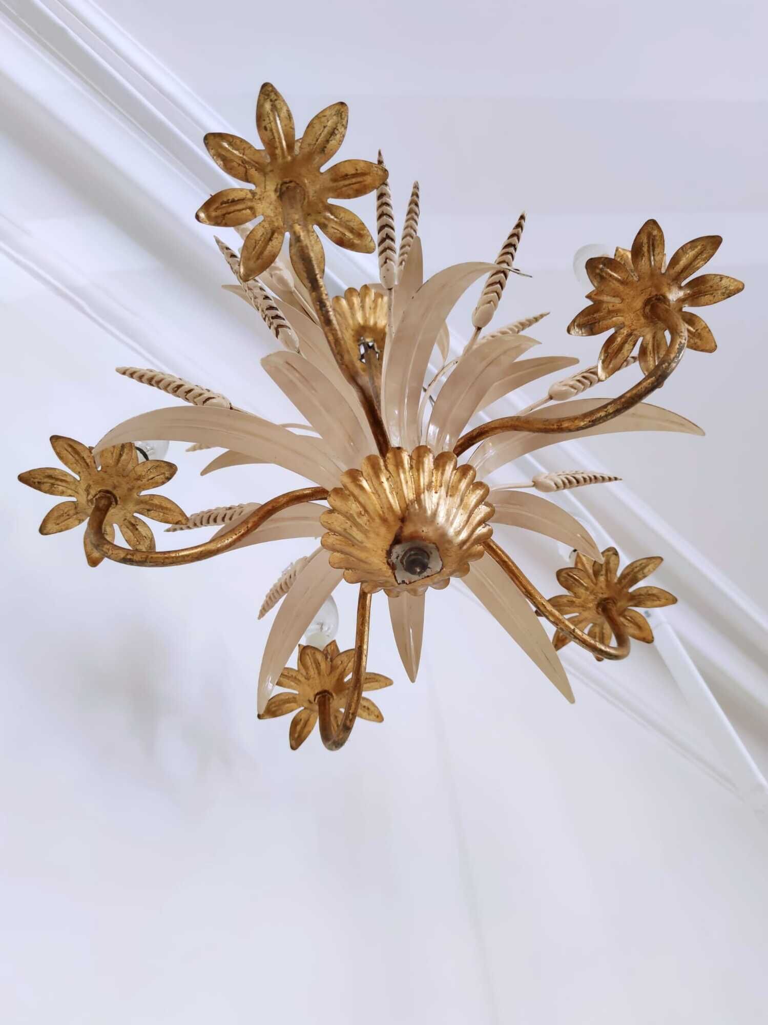 Vintage wrought iron chandelier decorated with golden and beige reeds
