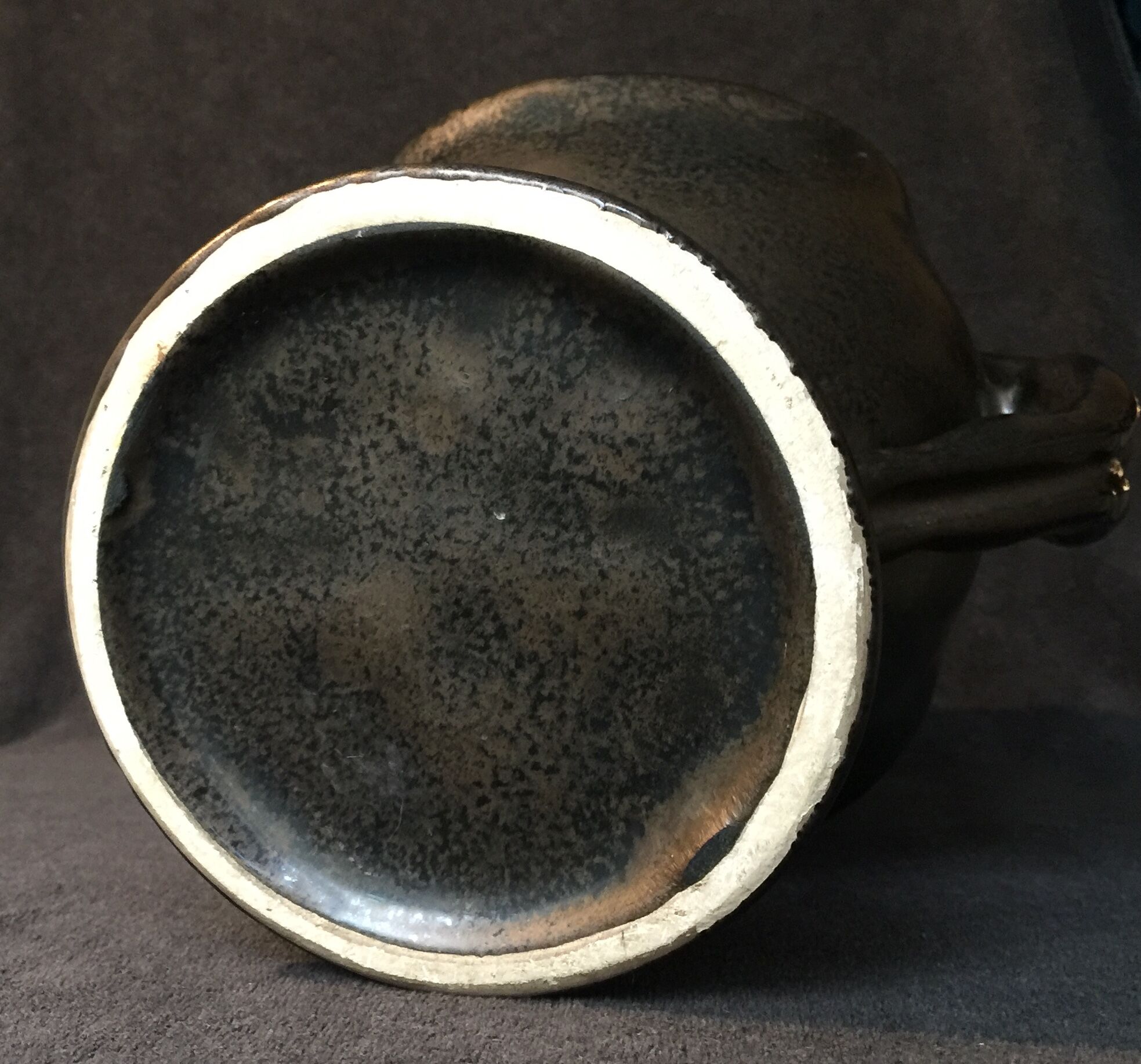 Black ceramic vase caught in naked women's bodies