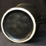 Black ceramic vase caught in naked women's bodies