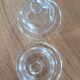 2 transparent glass butter dishes accompanied by their matching cloches.