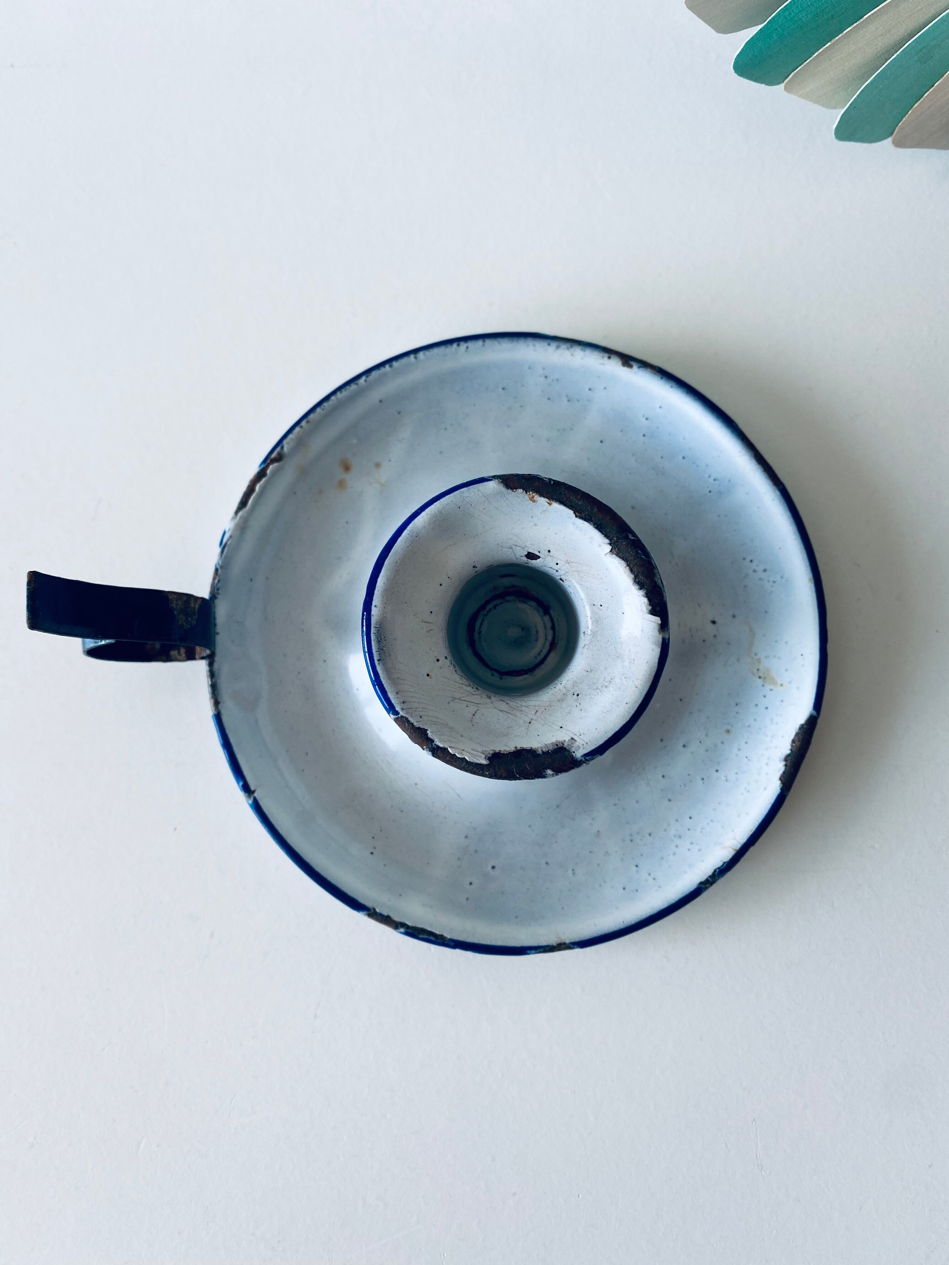 Antique candle holder in white and blue enamelled metal